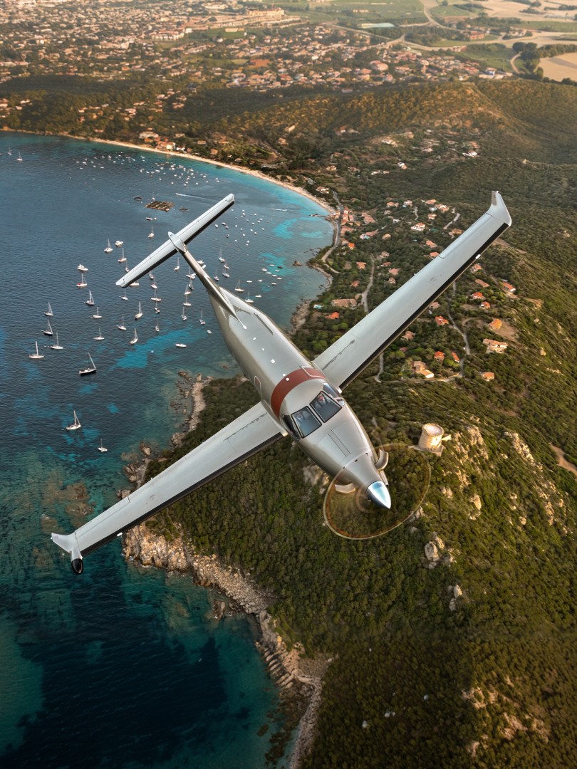 Pilatus PC-12 flying over coast