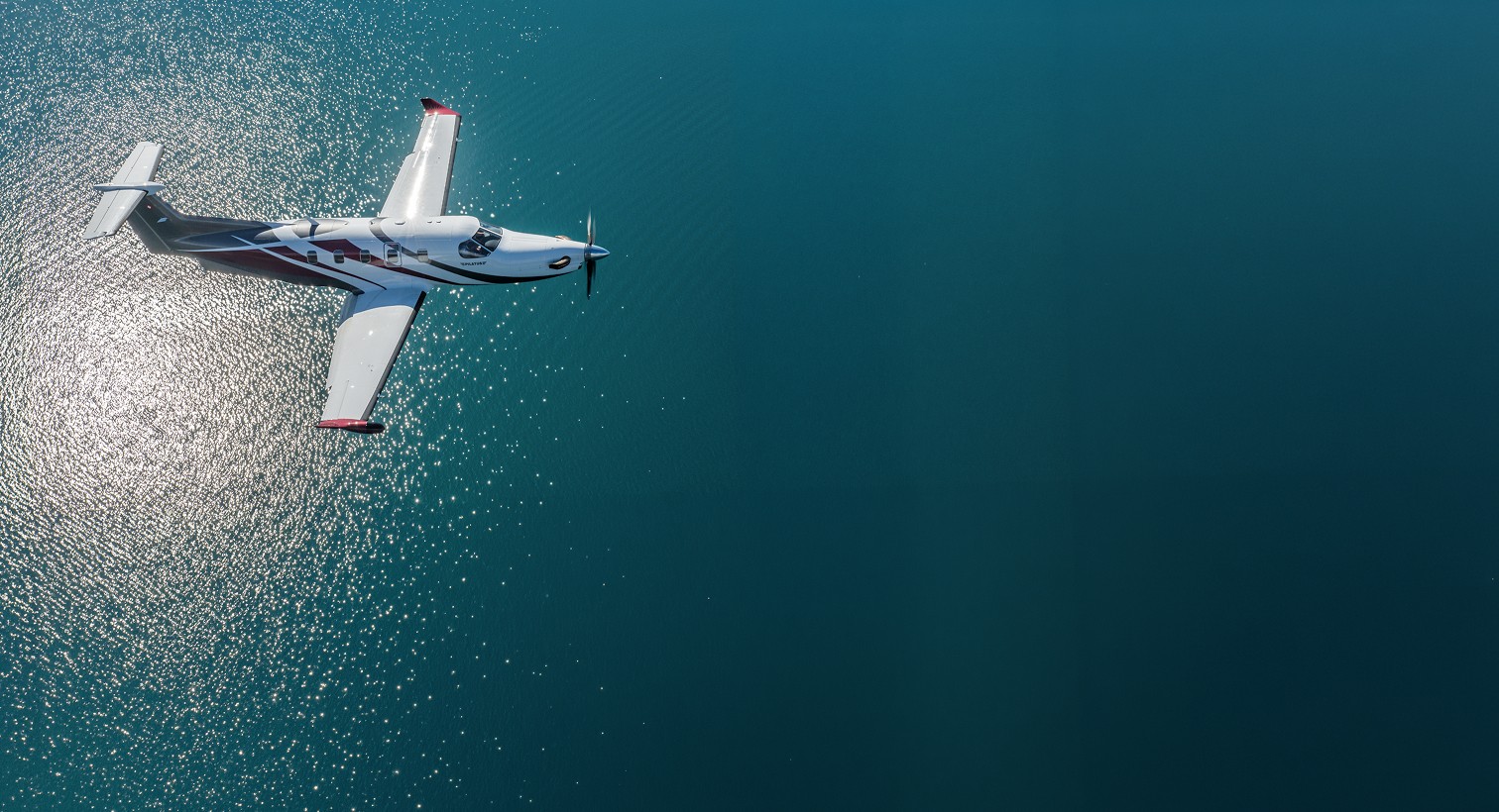 Pilatus PC-12 survolant un lac